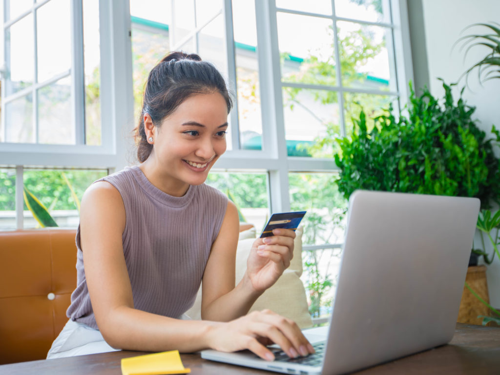 Asian Woman Is Holding Credit Card And Using Smartphone Shopping